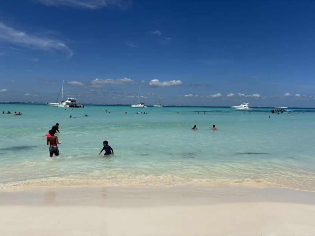 Playa Norte beach on Isla Mujeres with turquoise water and palm trees｜イスラ・ムヘーレス島のプラヤ・ノルテ、ターコイズブルーの海とヤシの木が並ぶ風景